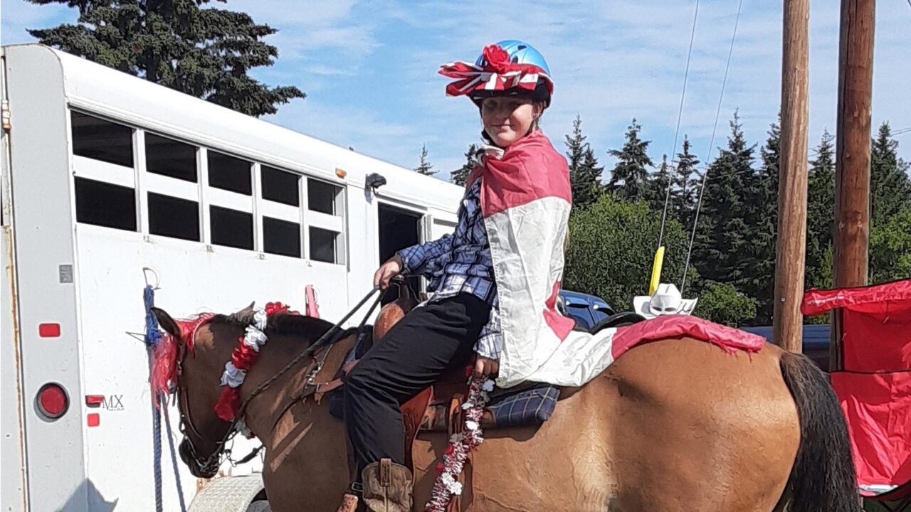 Girl in flamboyant costume on her horse